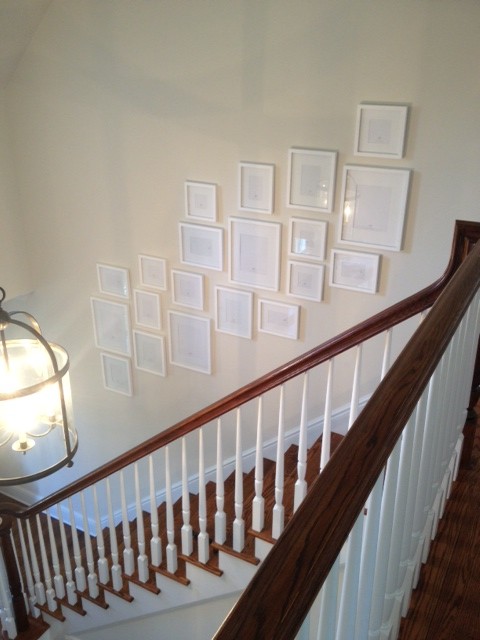 gallery wall stairway all white photos