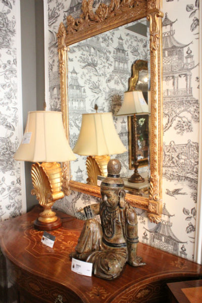 gold mirror hung over wallpaper 2