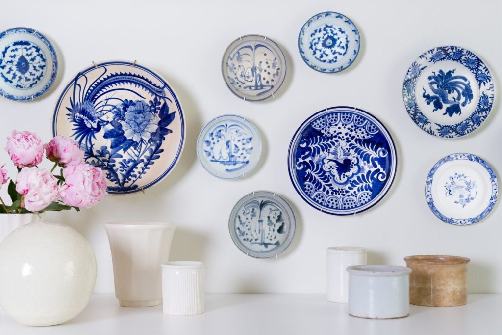 A display of blue and white plates on a white wall