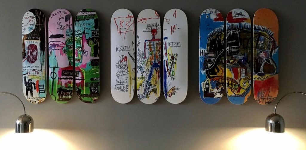 Nine skateboard decks arranged on a wall