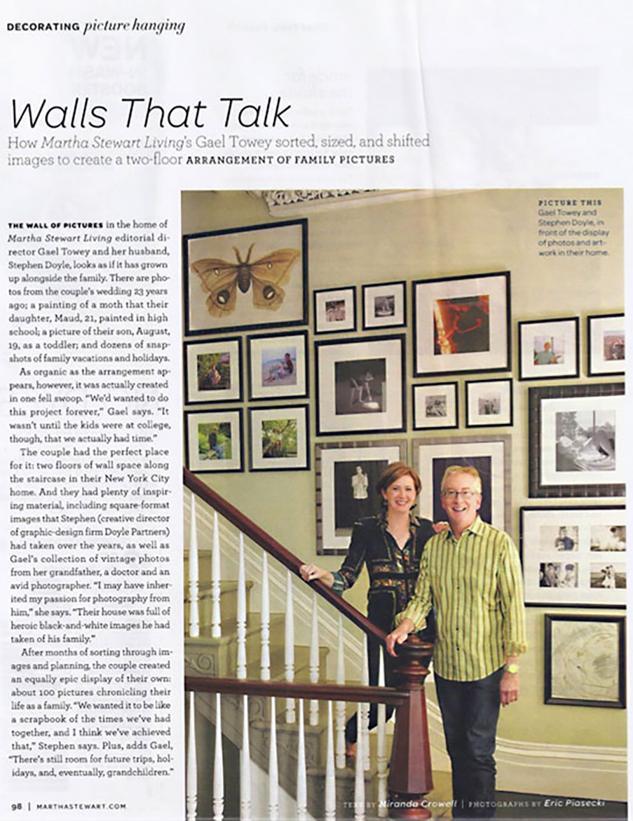 Photo of Martha Stewart Living magazine, cover photo is of two people standing on a staircase next to a large collection of art hung well on a wall, the headline reads "walls that talk"
