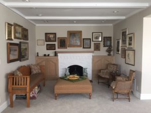 Small sitting room with gallery walls on three walls