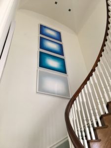to show art beautifully hung on a staircase