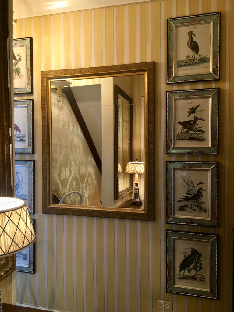 A large mirror on a wall shows how mirrors make rooms look bigger