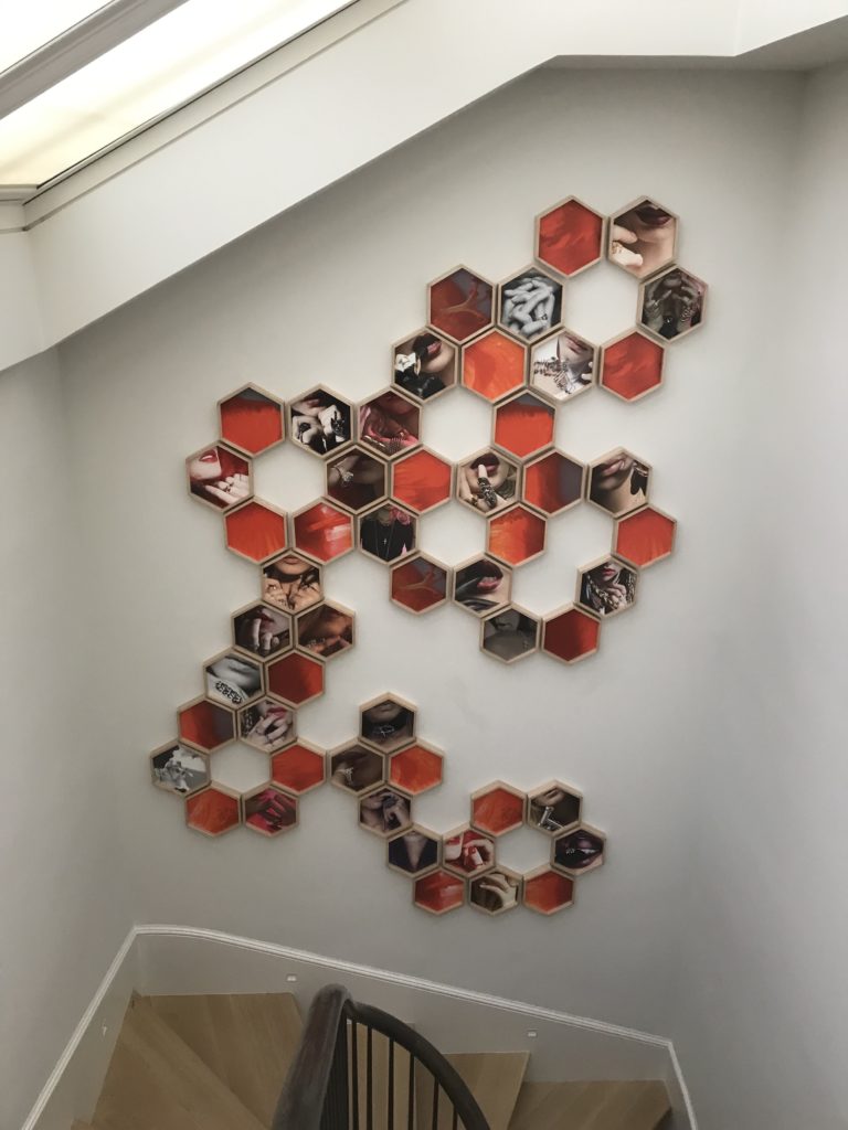 54 hexagonal frames create a statement piece on a stairway wall