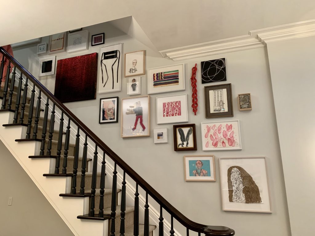 a gallery wall in a stair well