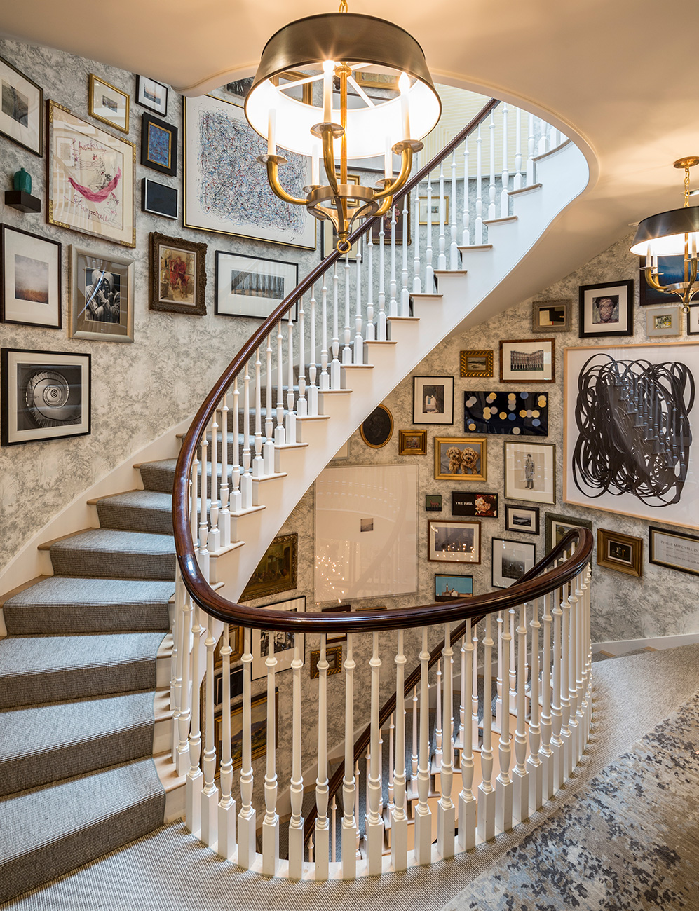 Picture of spiral staircase with large collection of framed art