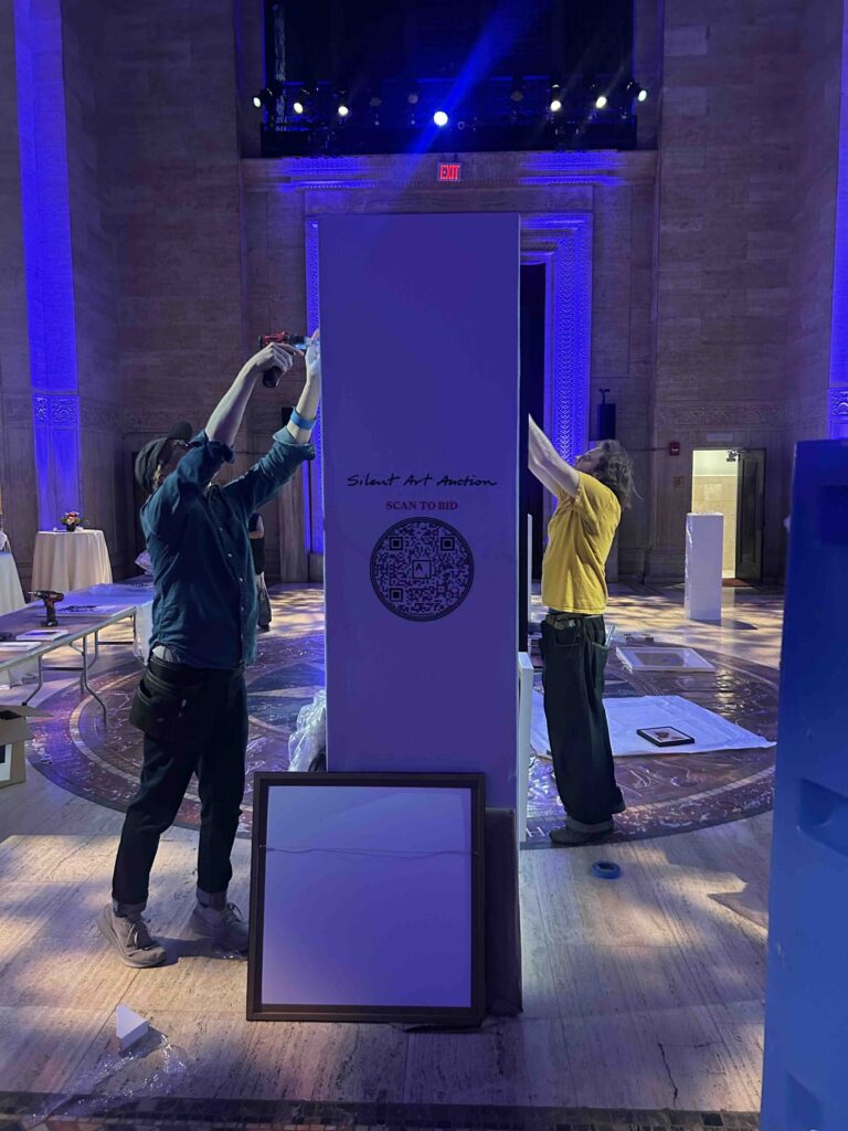 ILevel art handlers installing a wall panel during setup for the Housing Works Groundbreaker Awards Gala