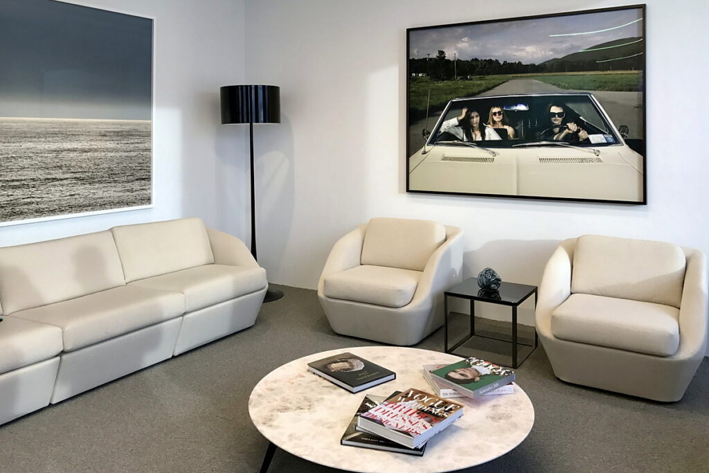 Oversized framed photographs installed in a commercial building amenity lounge