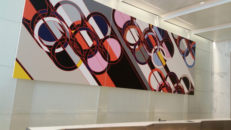 Large-scale commissioned mural installed above the reception desk in a New York commercial building lobby