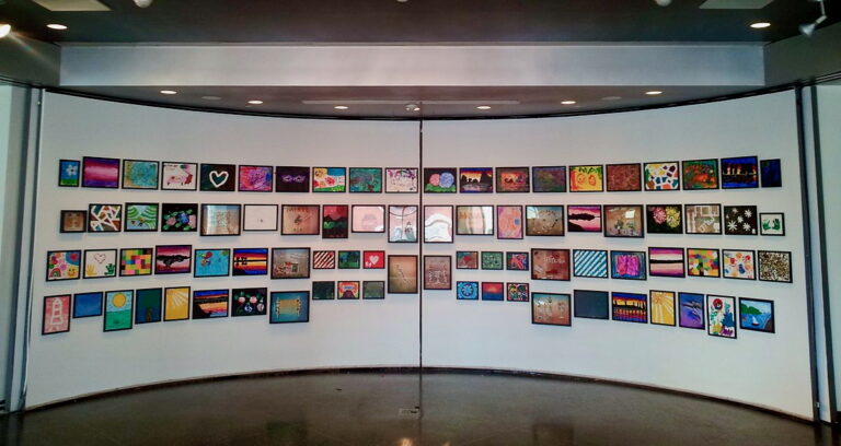 Series of framed landscape photographs installed in a staggered grid