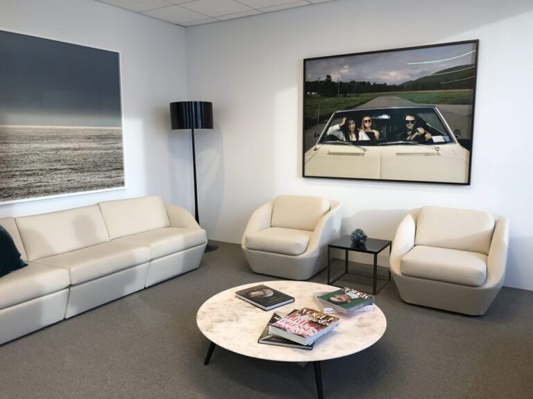 Framed photography installed in a corporate office lounge.