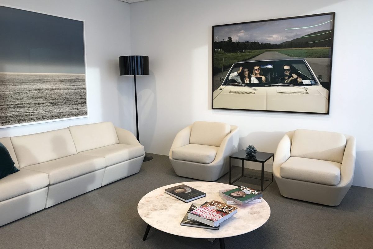 Framed photography installed in a corporate office lounge.