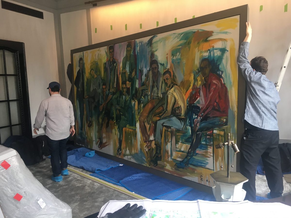 two art handlers carrying oversized canvas